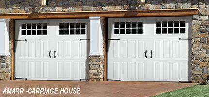 2 white garages that has 2 white doors each and has carriage house design