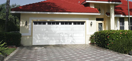 A house with red roof, white wall and white garage door