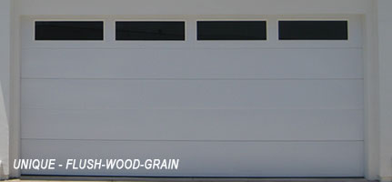 White garage door that is flush-wood-grain