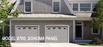 A house with 2 garages that has white doors and sonoma panels
