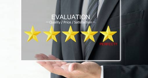 A man with a suite holding a 5 yellow star ratings